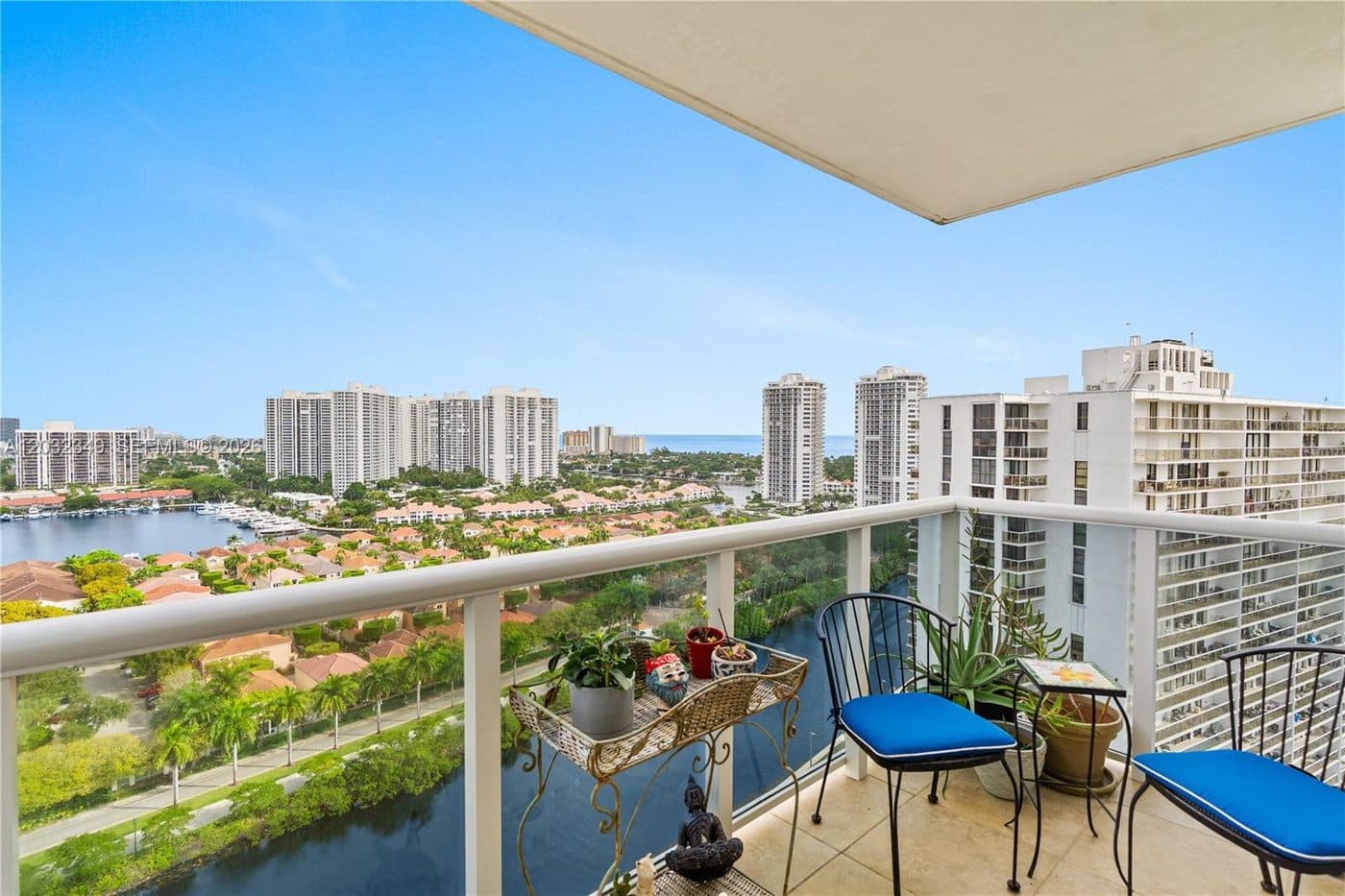 A balcony with chairs and a view of the towers and the Intracoastal
