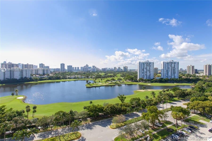 The towers beside the golf course and a lake, seen from above